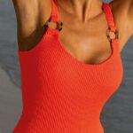 Model wearing the Bravissimo Miami Swimsuit in neon papaya
