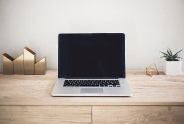 Laptop on a desk in a home workspace
