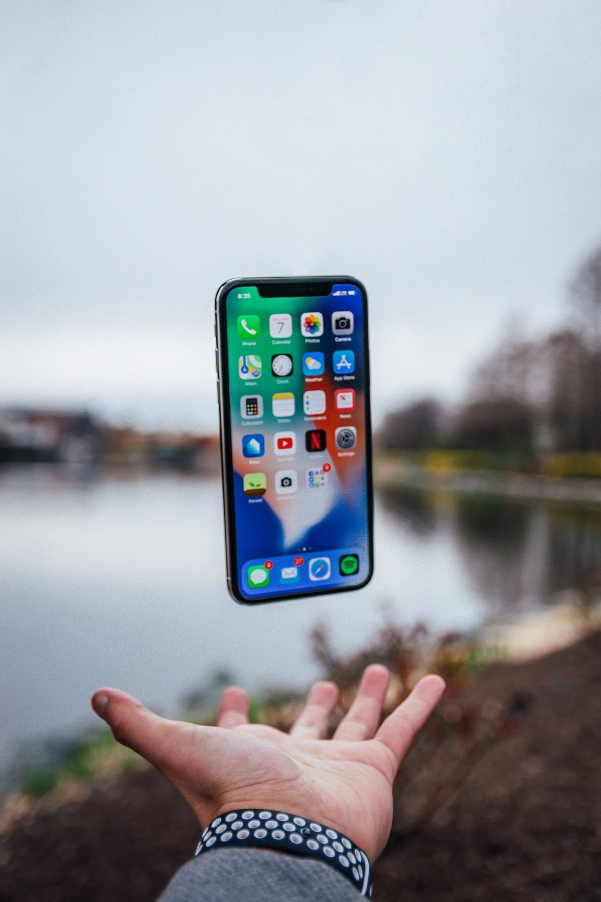 Smartphone resting on a desk beside everyday items