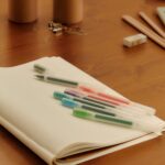 MUJI stationery arranged on a wooden desk