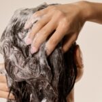 Close-up of hair being washed with shampoo lather