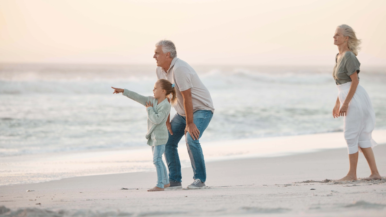 Grandparent and grandchild spending time together on a beach