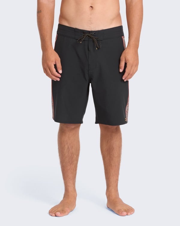Model wearing black DBAH Pro boardshorts