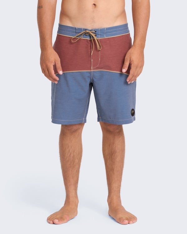 Model wearing beige Garage Arch boardshorts