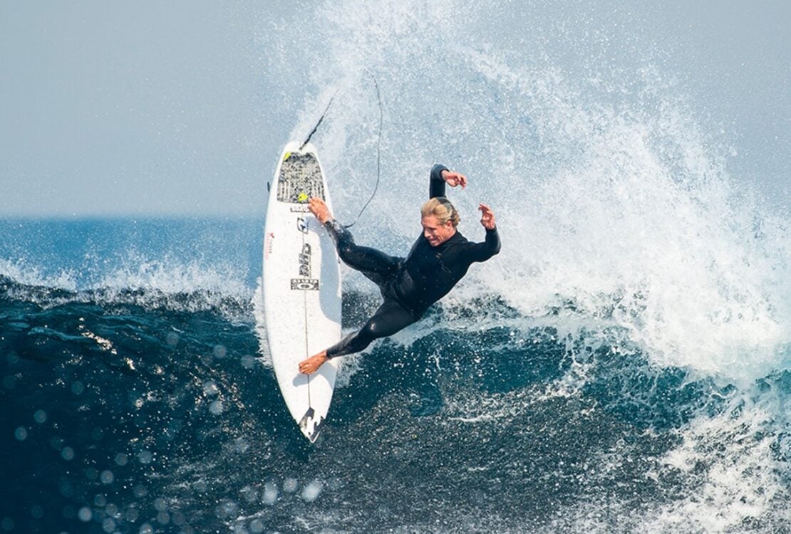 Surfer carving a turn on a wave in a Billabong surf campaign