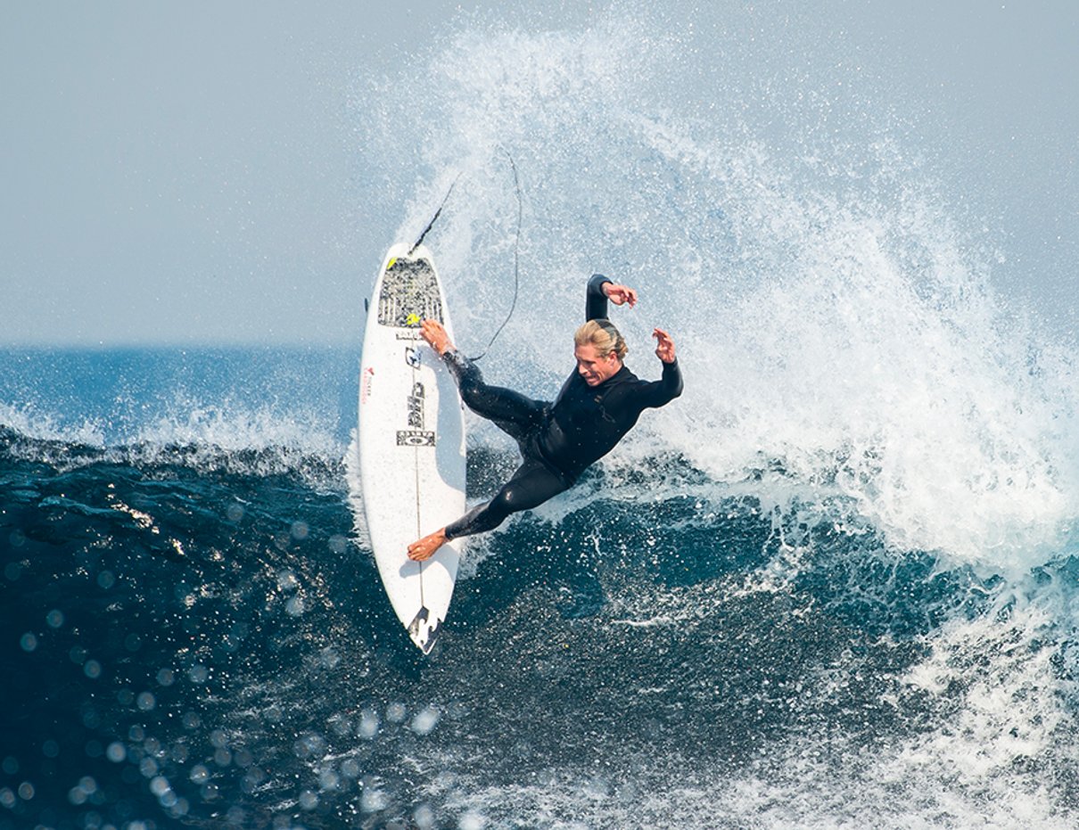 Surfer carving a turn on a wave in a Billabong surf campaign