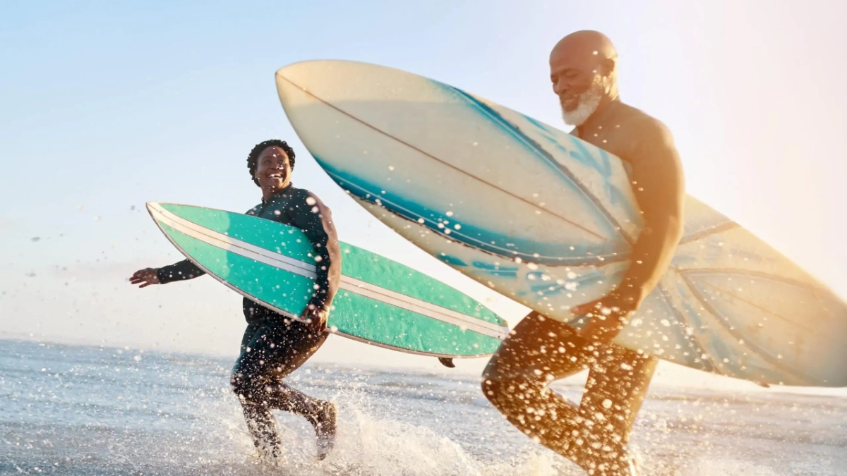 Mature couple enjoying a surf session at the beach