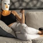 Person wearing an LED face mask during a home light therapy session