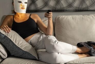 Person wearing an LED face mask during a home light therapy session
