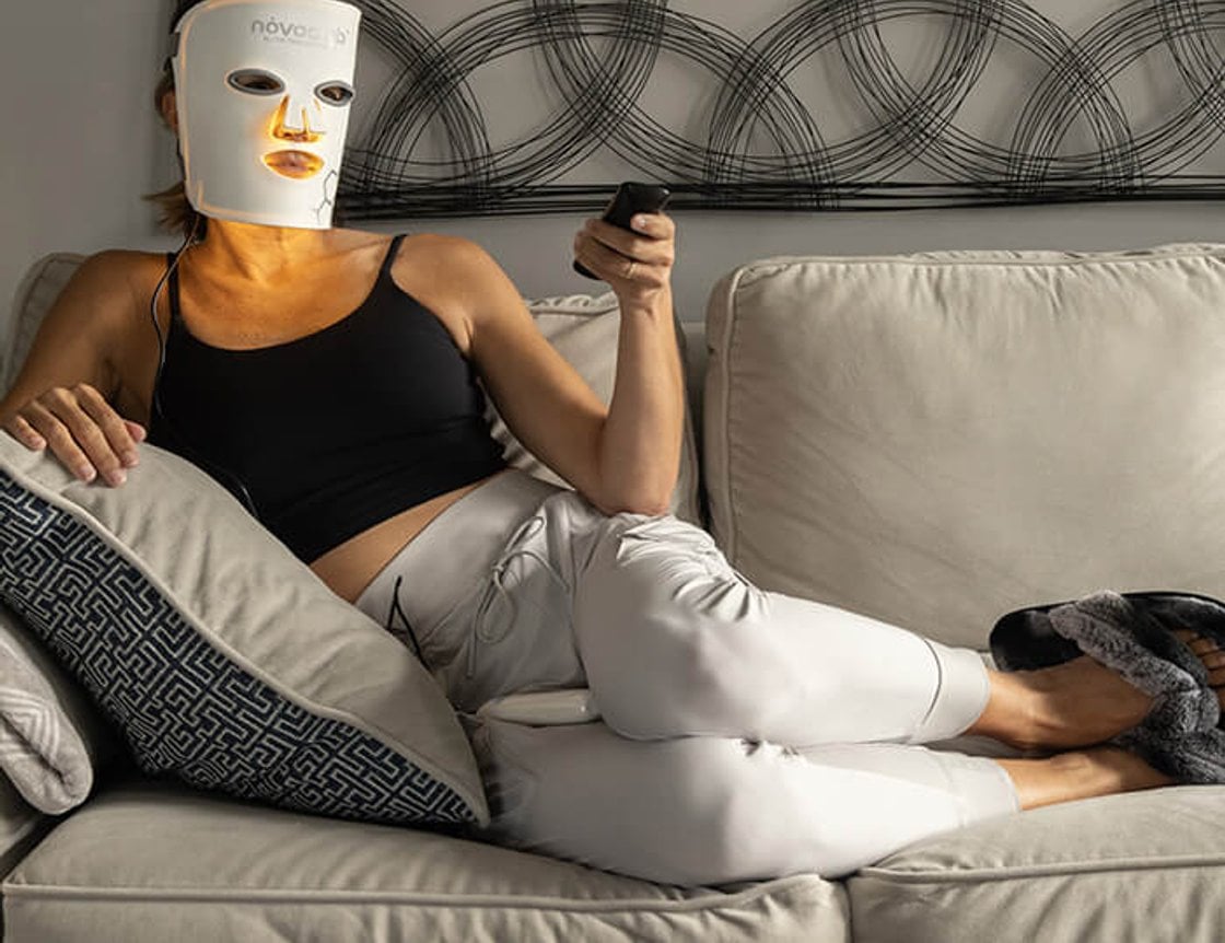Person wearing an LED face mask during a home light therapy session