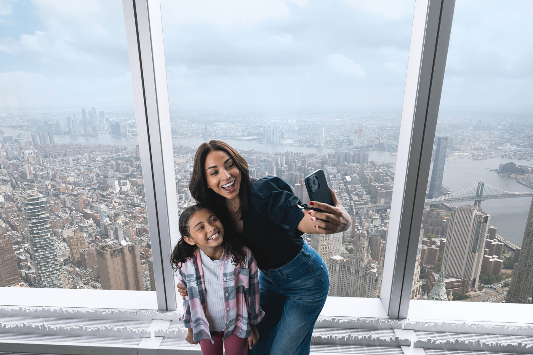Family looking out over the city from an observation level