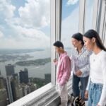 Family looking out across the New York skyline from the observation deck