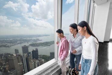 Family looking out across the New York skyline from the observation deck