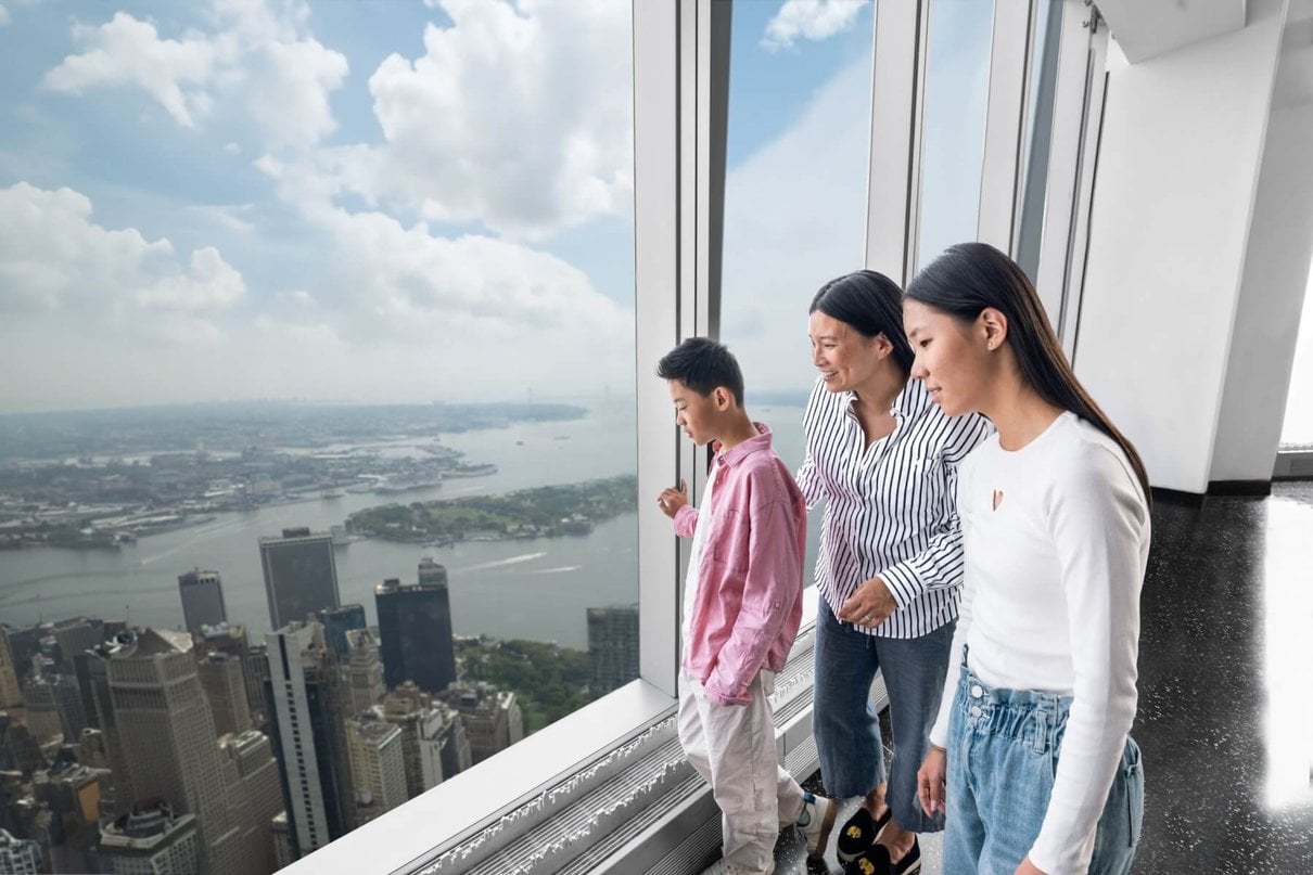 Family looking out across the New York skyline from the observation deck
