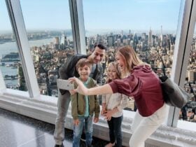 Family taking a selfie with New York City visible from the observatory