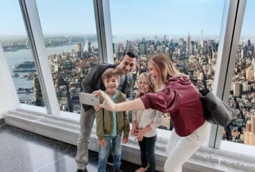 Family taking a selfie with New York City visible from the observatory
