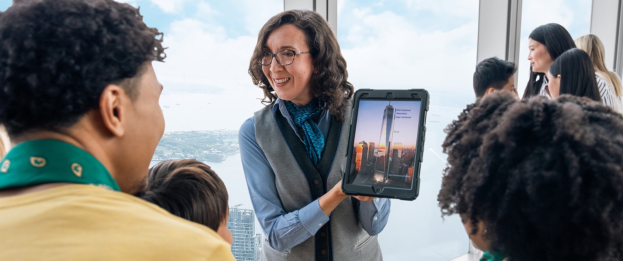 Guide speaking with visitors inside One World Observatory