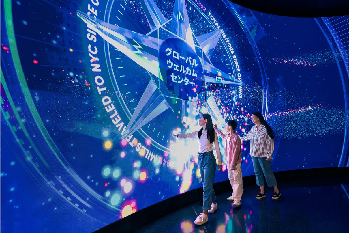 Visitors at the One World Observatory welcome wall