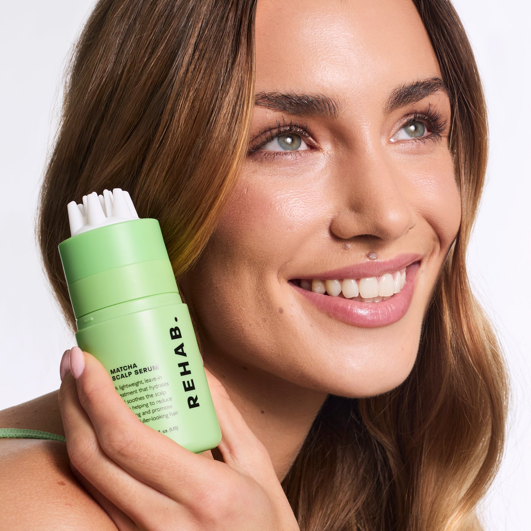 Model applying REHAB Your Hair Matcha Scalp Serum