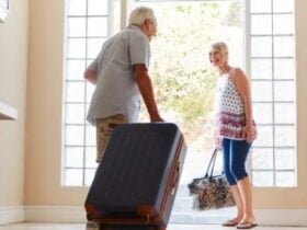 Older couple setting off with suitcases for a holiday