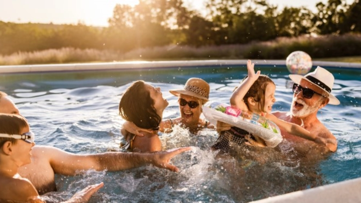 Several generations of a family enjoying a pool holiday
