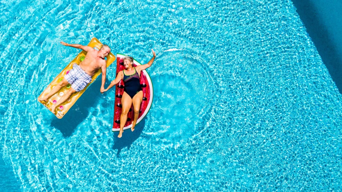 Older couple relaxing in a swimming pool