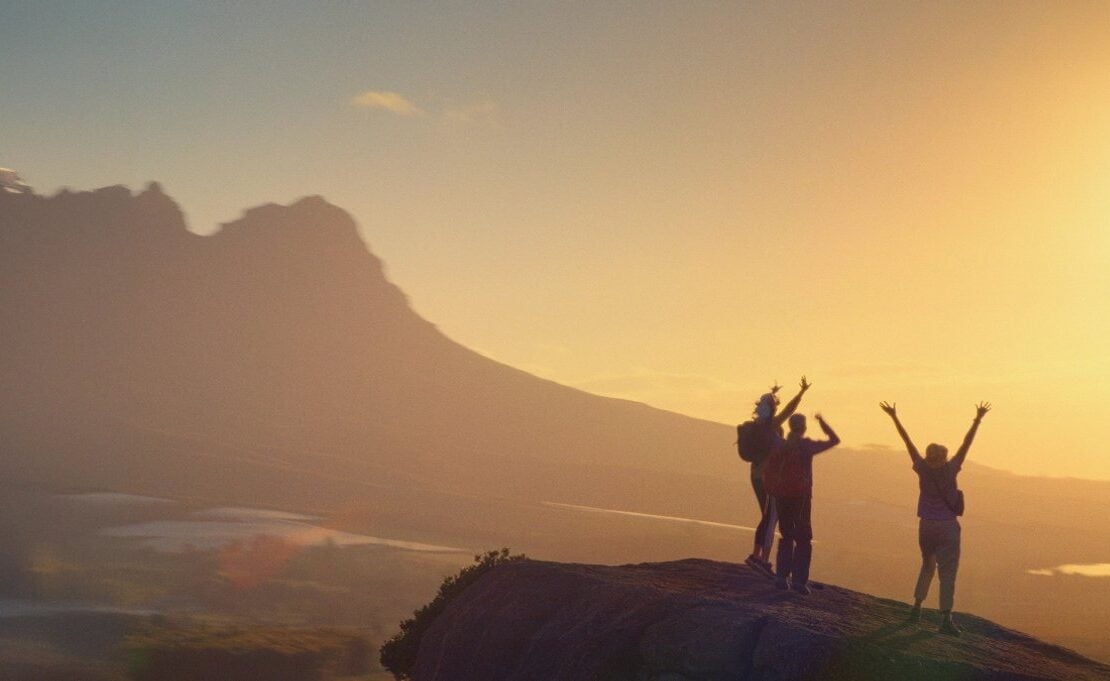 Travellers hiking along a mountain path