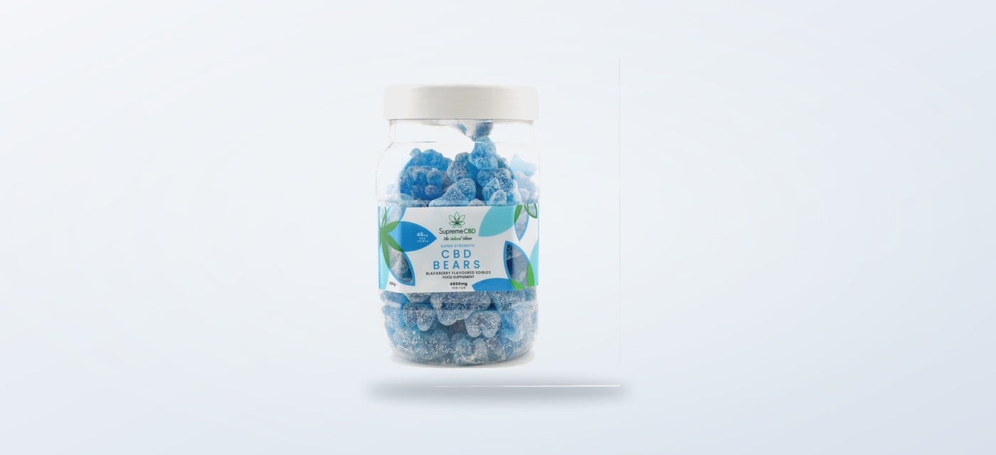 Blue CBD gummy bears in their product tub
