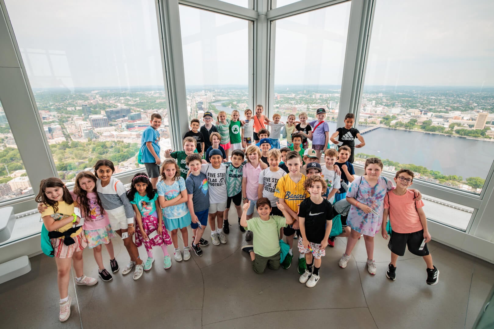 Visitors inside View Boston looking out through the observatory windows