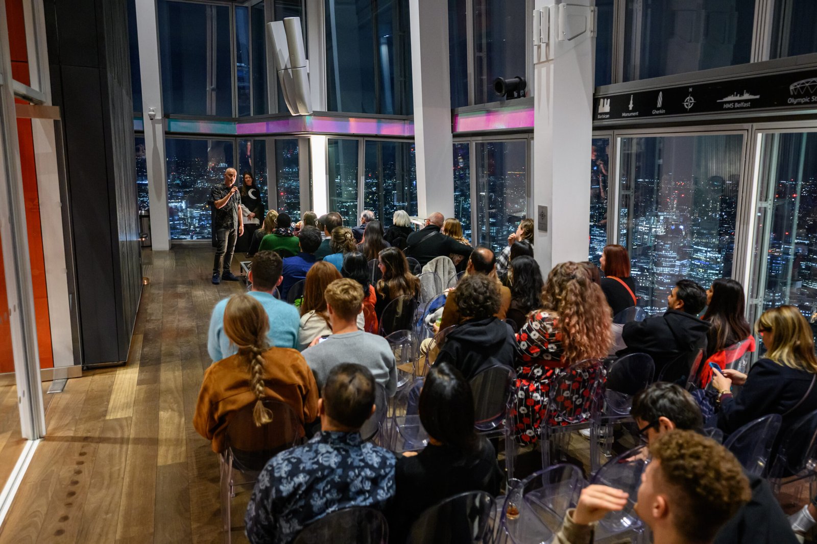 Audience watching the nighttime London skyline at an event in The Shard